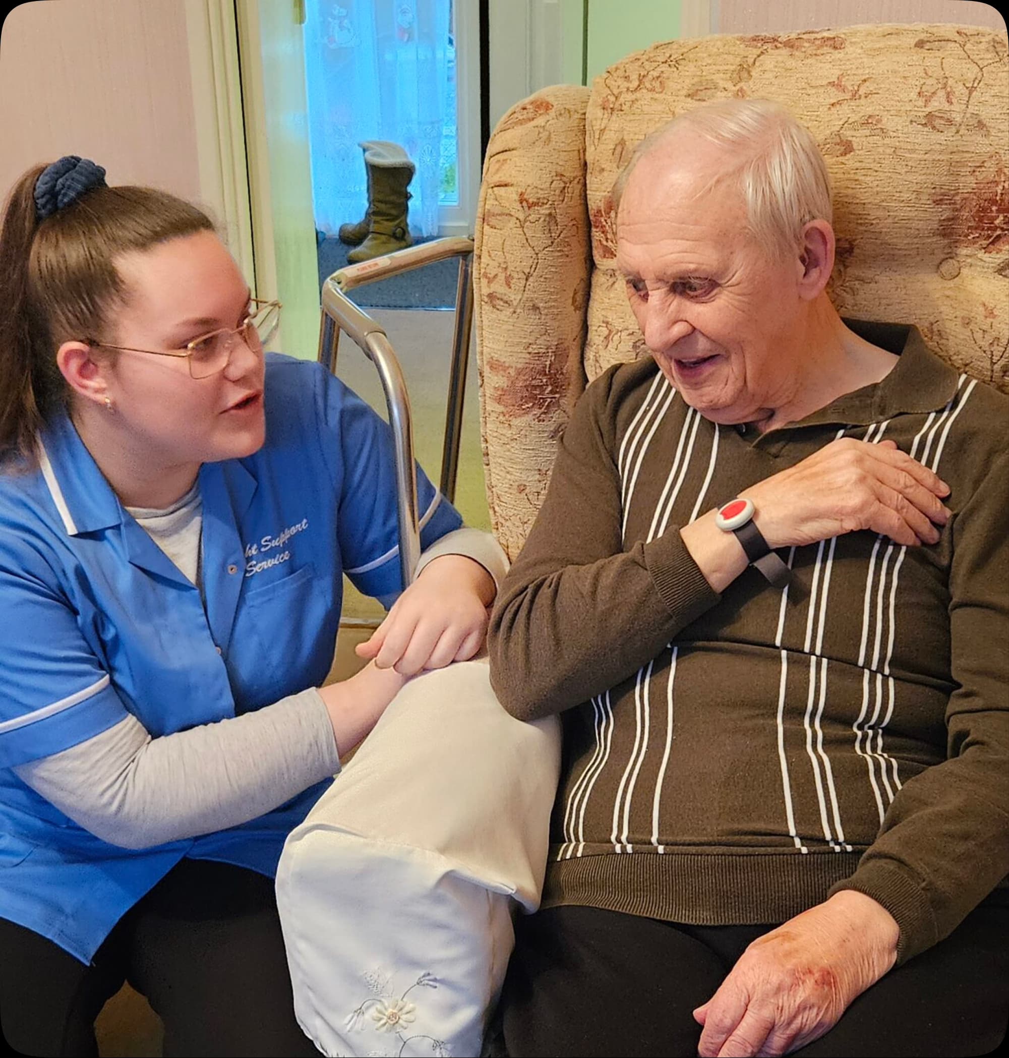 A Delight Support carer sitting with an elderly client at home during a care assessment