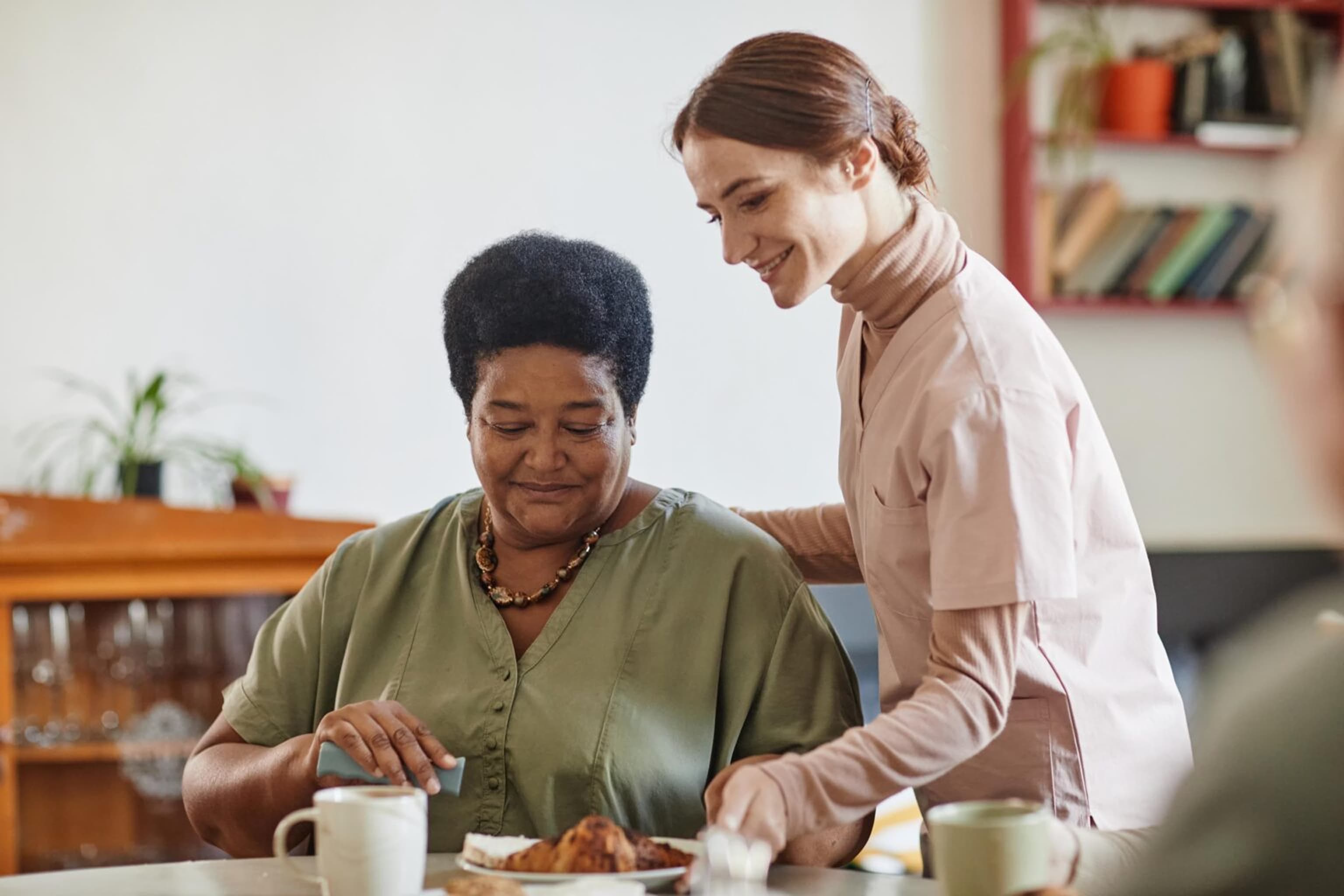 A Delight Support carer helping an elderly woman at home in Sheffield